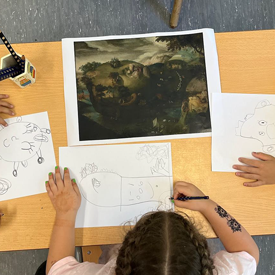 Plan vu d'en haut montrant des enfants en train de dessiner d'après la représentation d'un tableau